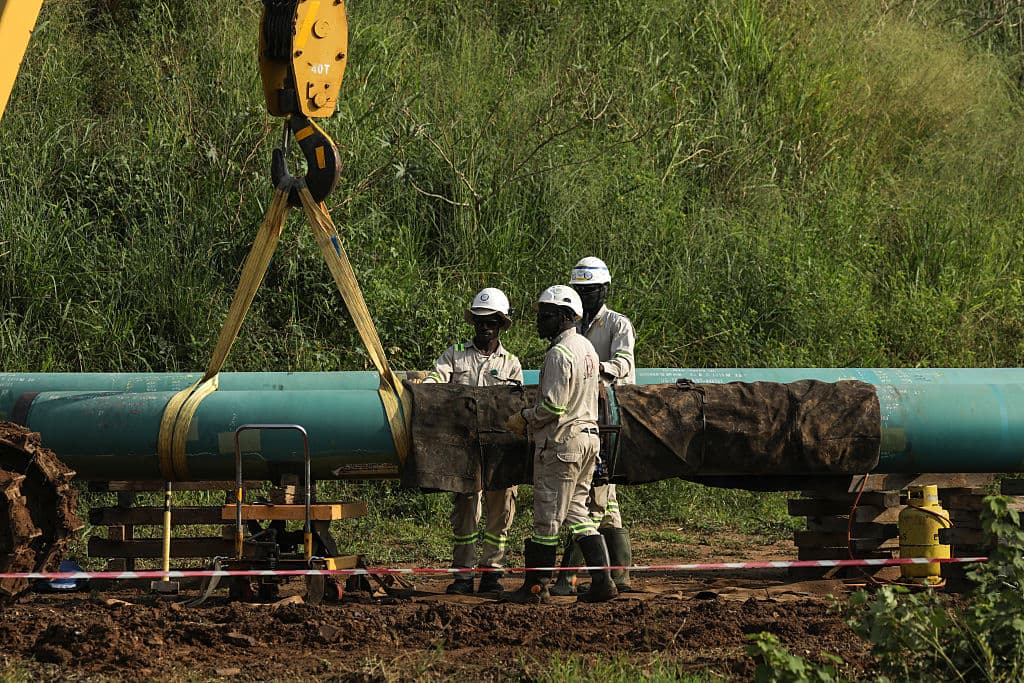 Workers laying pipe at the Tilenga oilfield near Lake Albert in Uganda, part of the East Africa Crude Oil Pipeline project