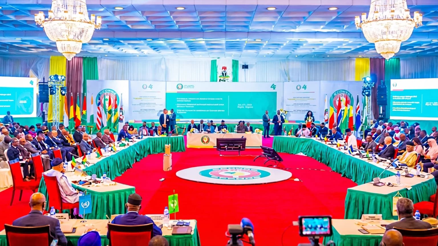 Delegates seated around a large conference room table during an ECOWAS session