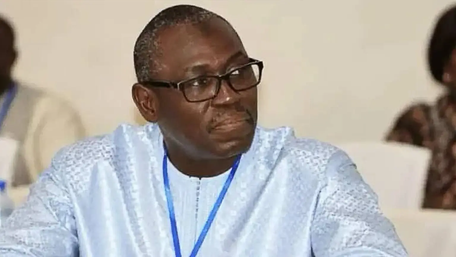 Portrait of a former Liberian government minister seated at a conference table