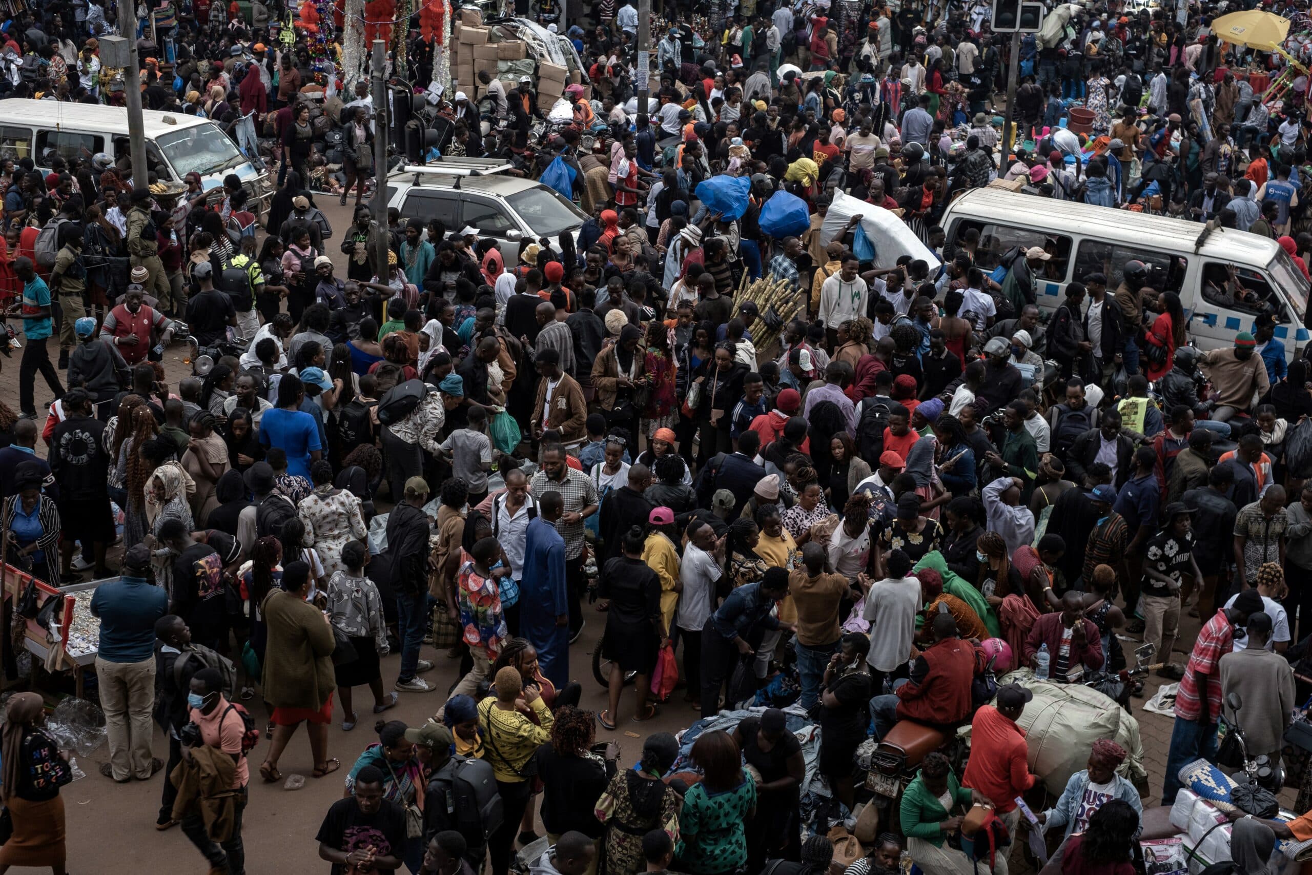 Vendors and buyers navigating a busy commercial street in downtown Kampala